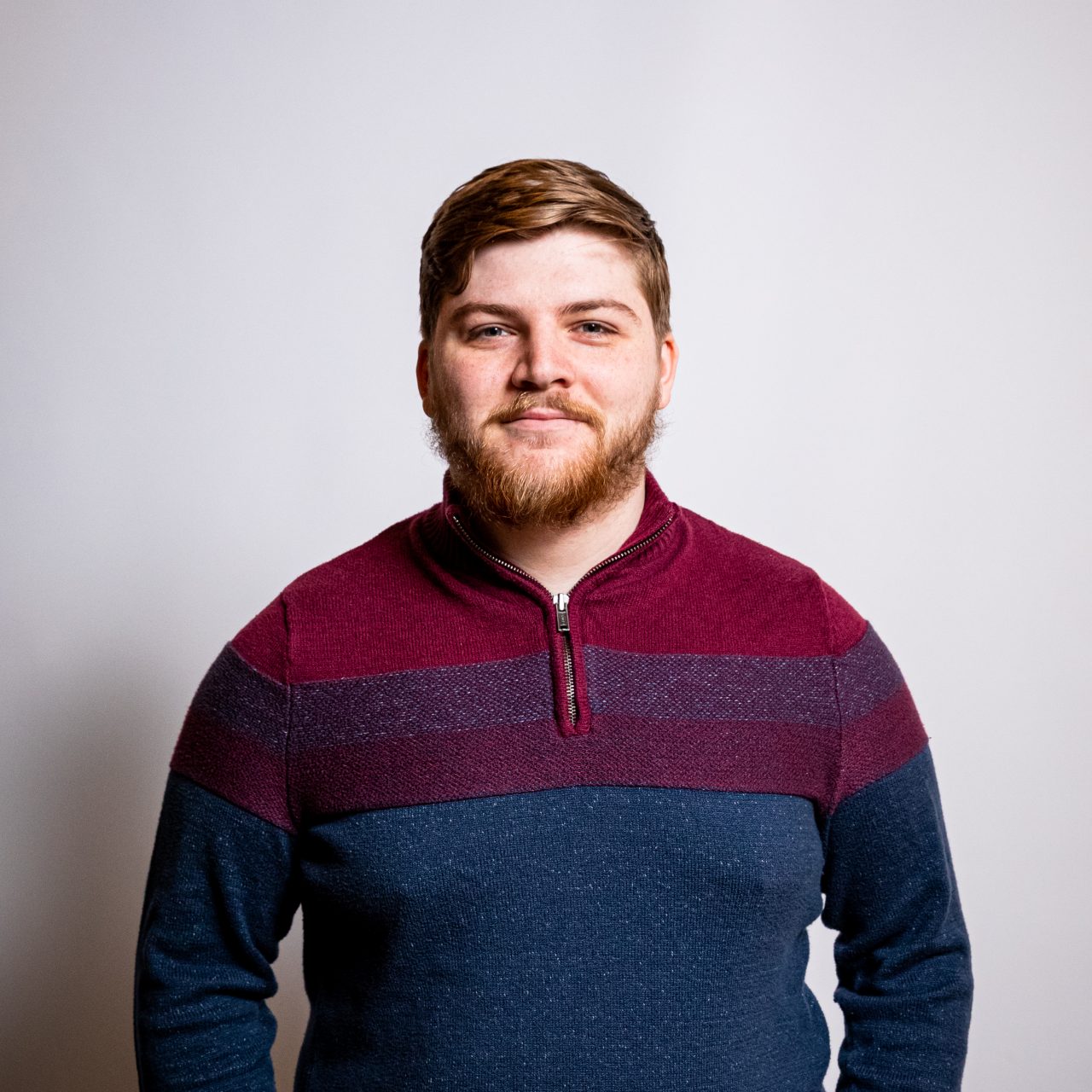 Profile image a student smiling in front of a wall