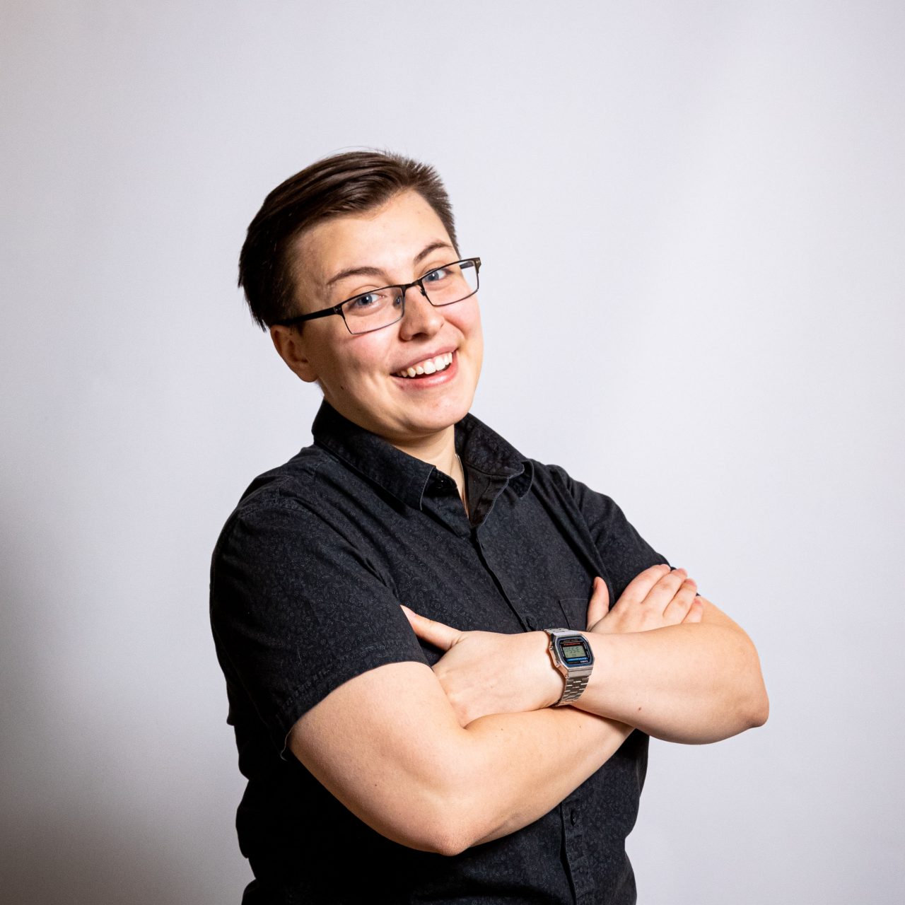 Profile picture of smiling student with arms crossed