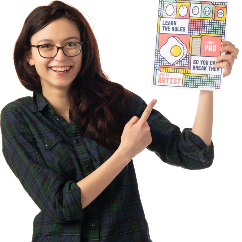 Profile image of a smiling student pointing at a book